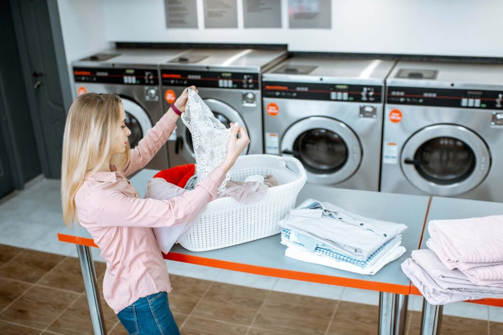woman sorting clothes in the laundry 9lnct23.jpg